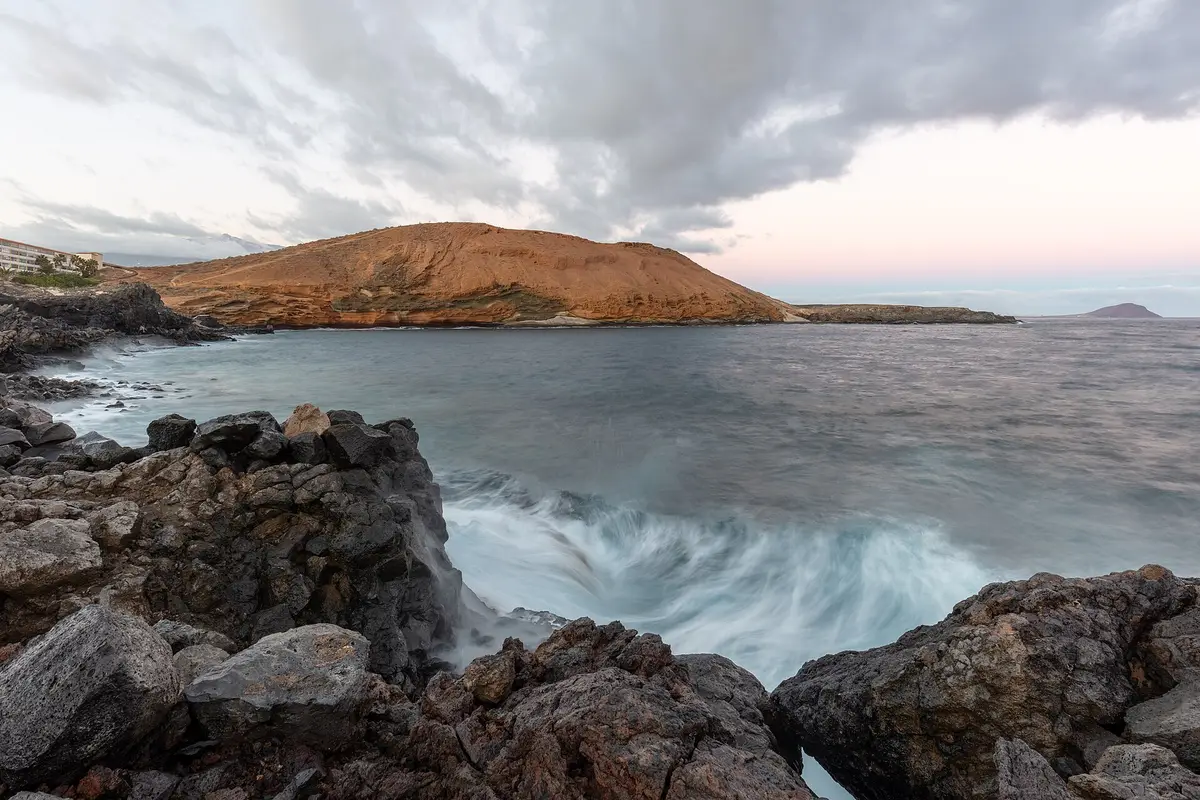 Volcanic coast and clear water at Montaña Amarilla