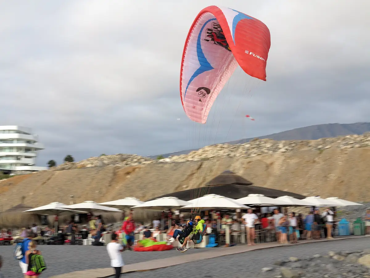Tandem paraglider landing on the coast near Costa Adeje, Tenerife